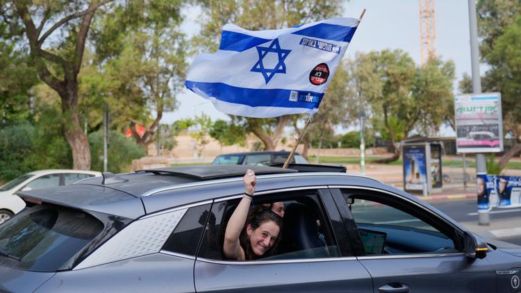 Israeli voters casting ballots in a bustling polling station during a national election.